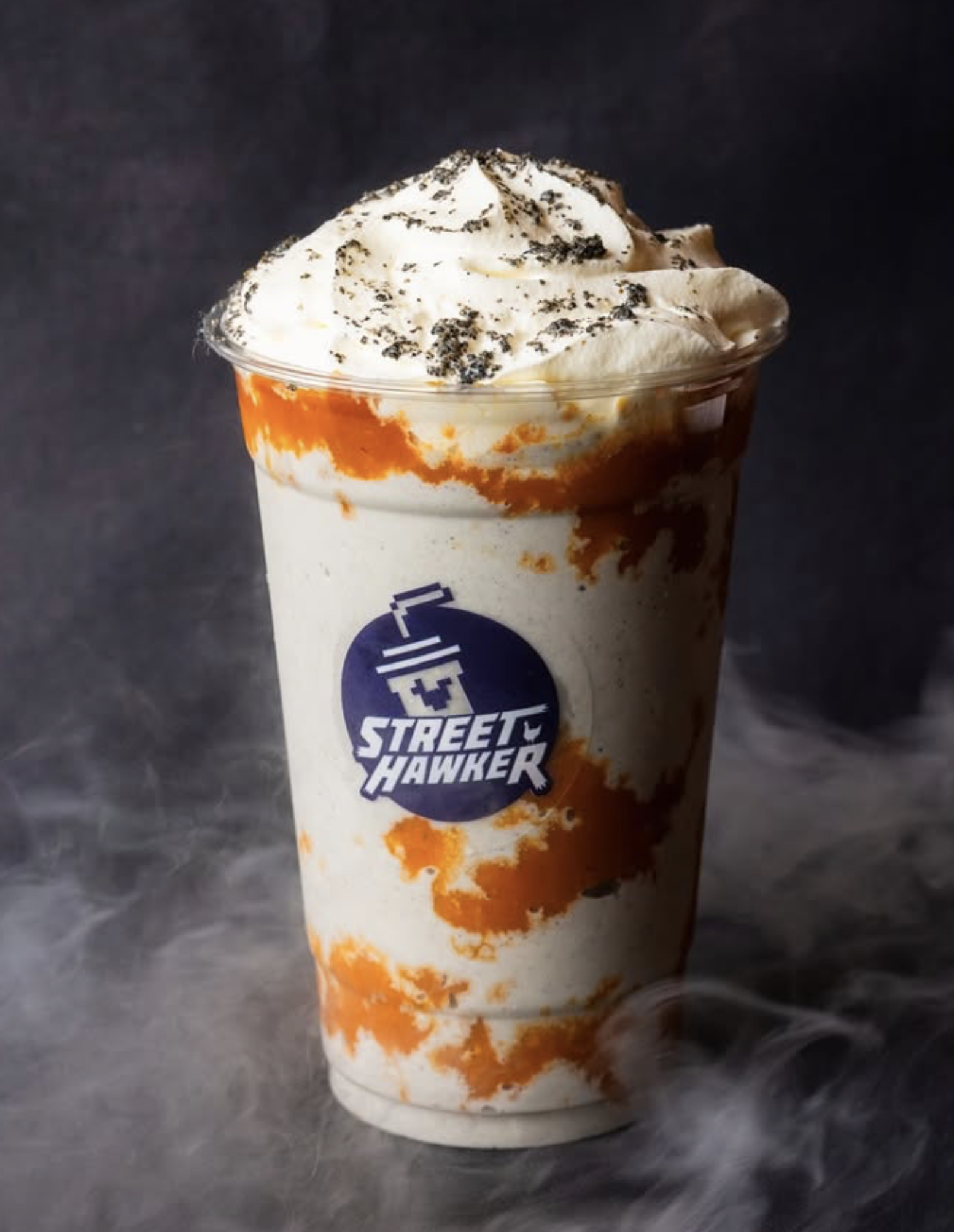 Retro-branded milkshake cup with whipped topping on an arcade-inspired background